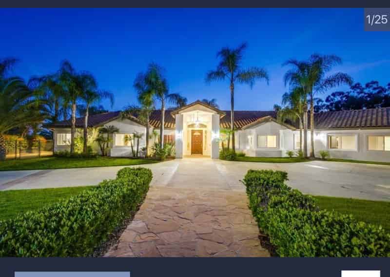a home with palm trees and a driveway
