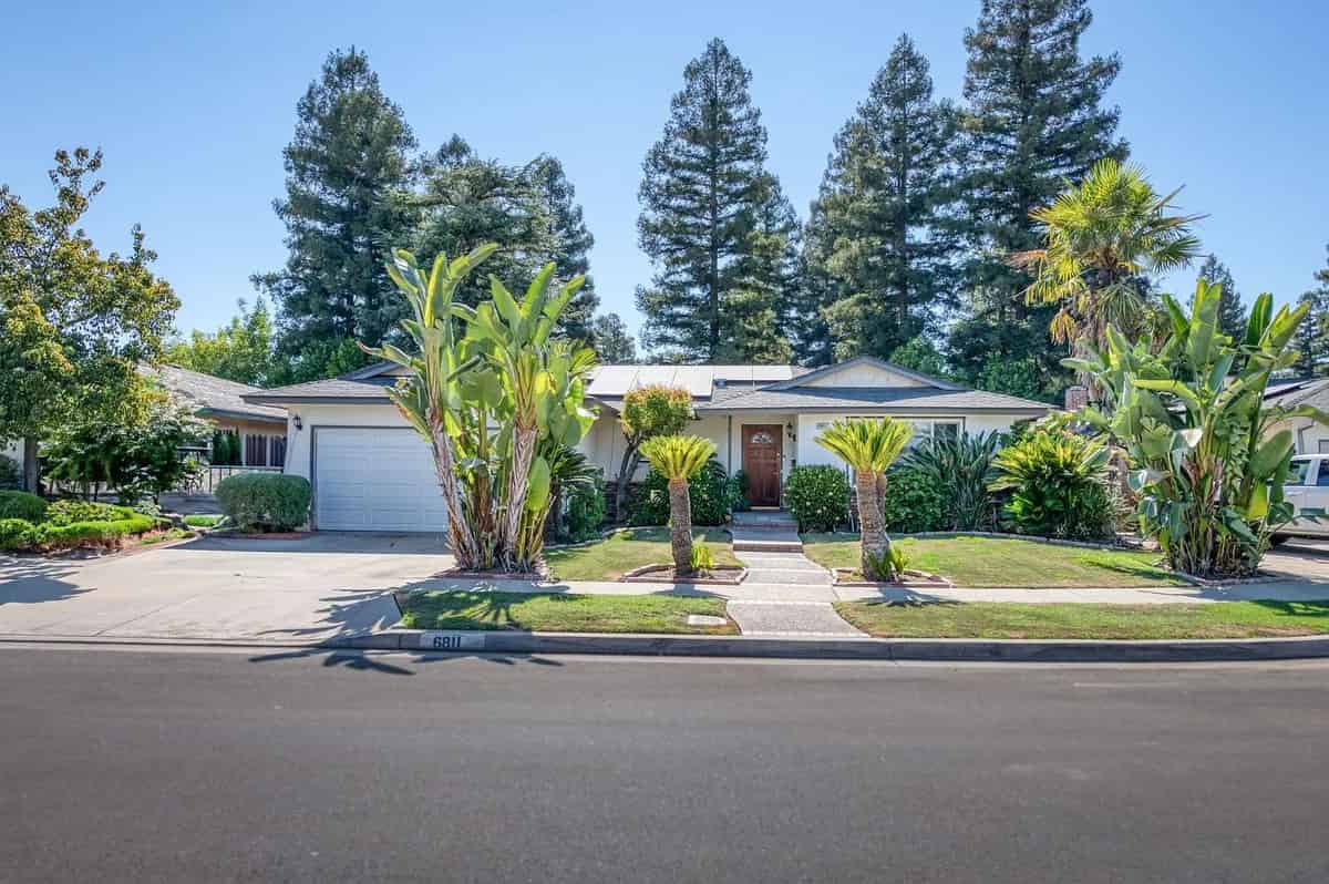a house with palm trees in front of it