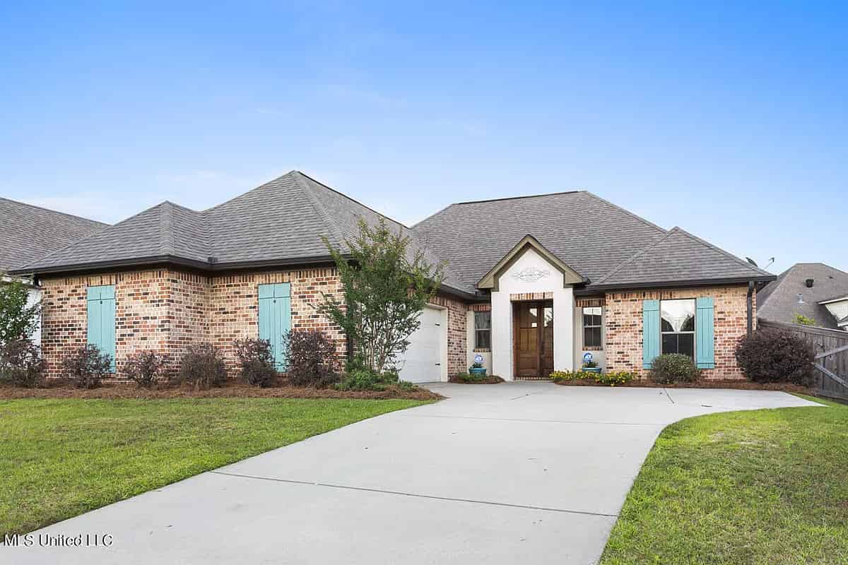 a brick house with a driveway and a driveway