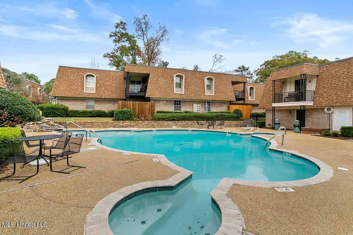 a swimming pool surrounded by a brick building