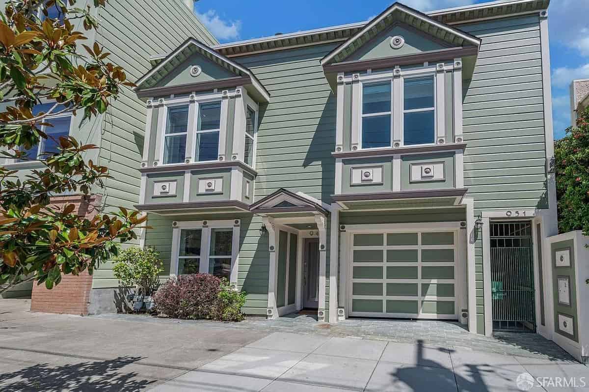 a two story townhouse with a garage and garage