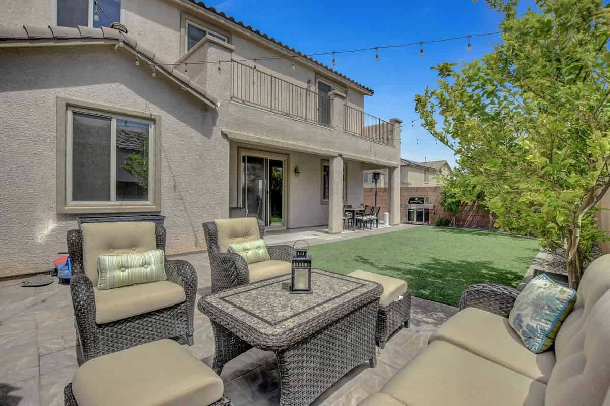 a patio with chairs and a table