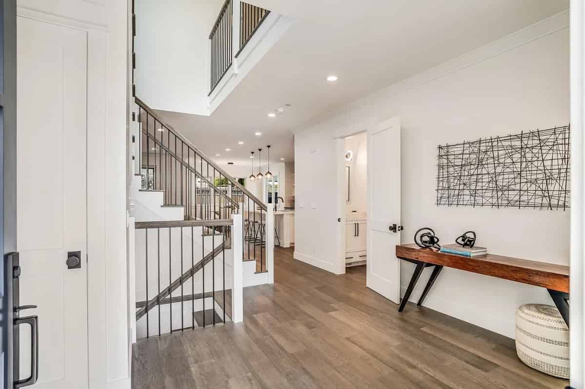 a hallway with a wooden floor and a staircase