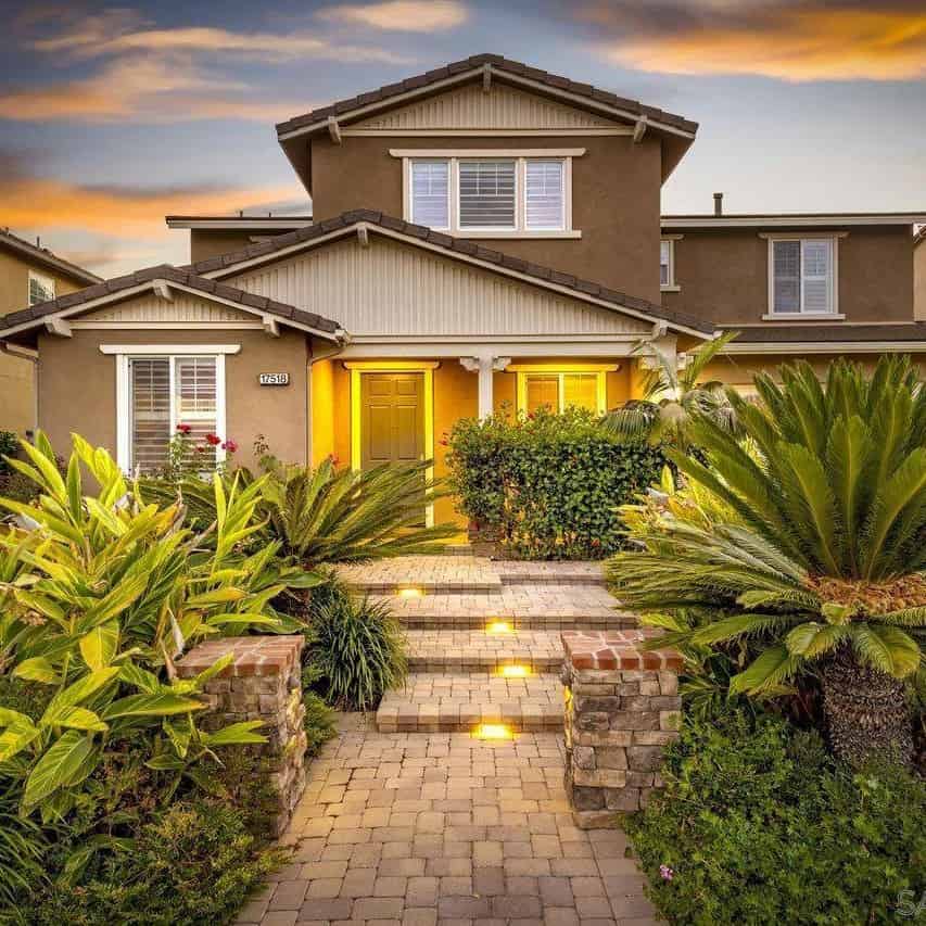 a house with a walkway leading to the front door