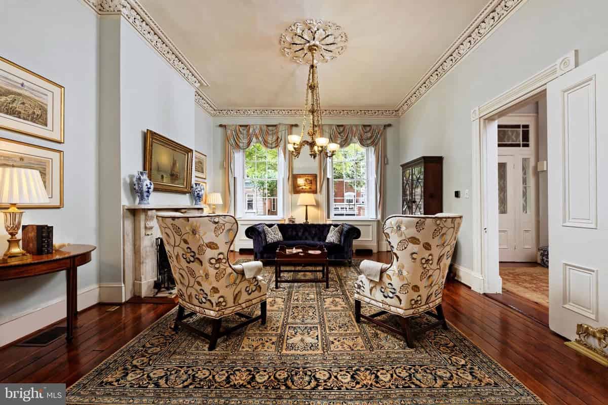 a living room with a couch, chairs, and a table