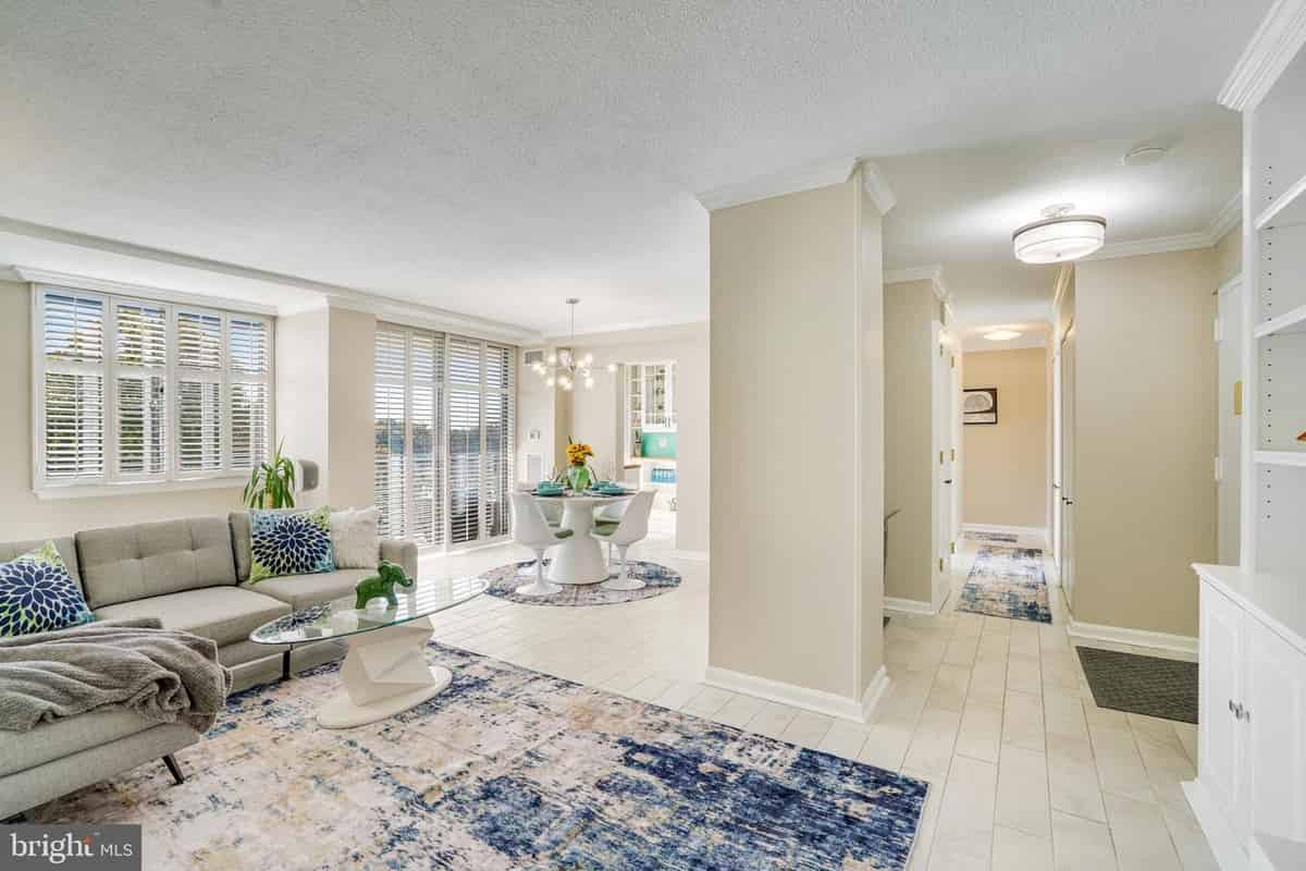 a living room with a couch, a table, and a window