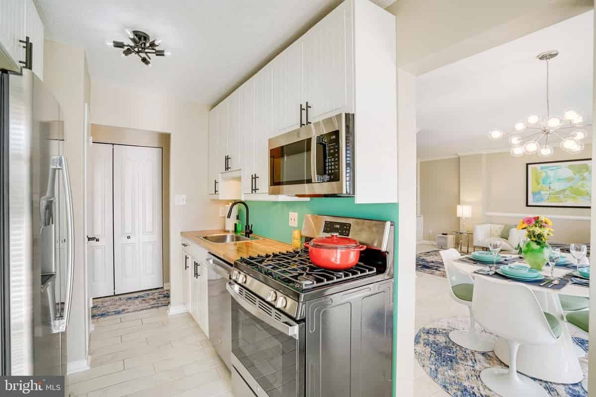 a kitchen with a stove, sink, and dishwasher