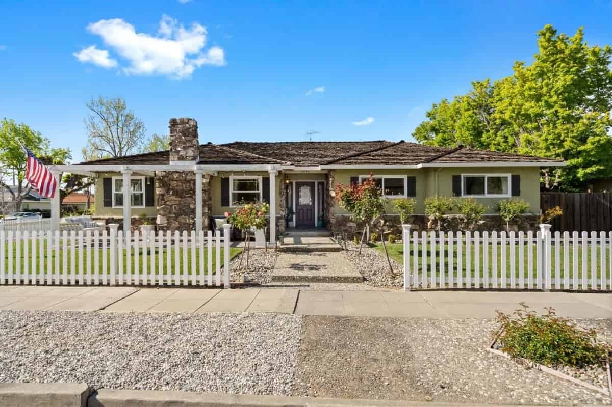 a house with a white picket fence in front of it