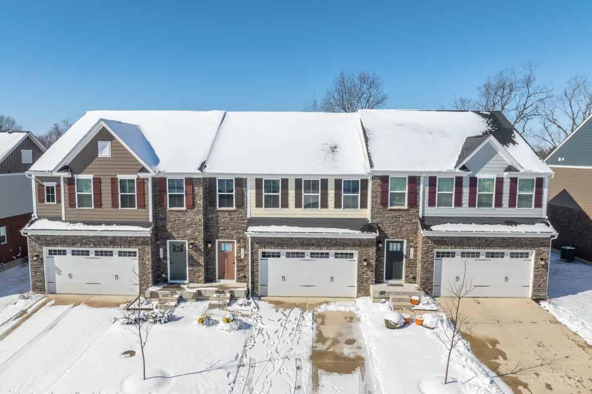 a home in the snow with a driveway