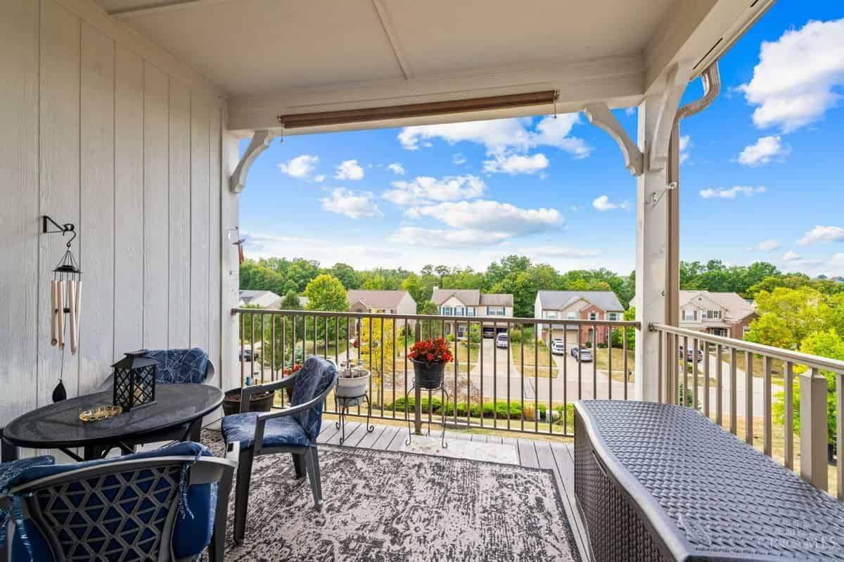 a balcony with a table and chairs