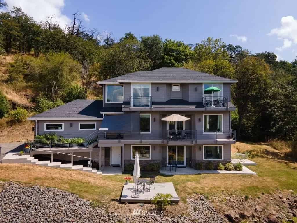 a house on the shore with a view of the ocean