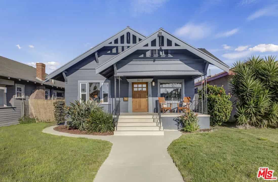 a small house with a front yard and a sidewalk