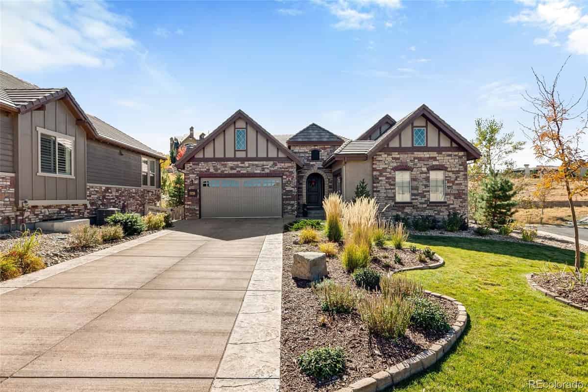 a home in colorado with a driveway and landscaping