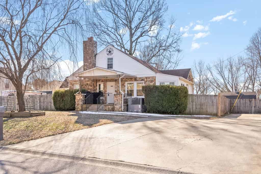 a house with a white roof and a fence