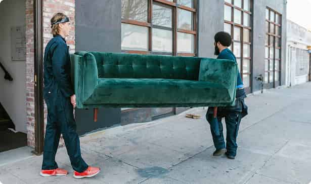 Movers carrying a green couch
