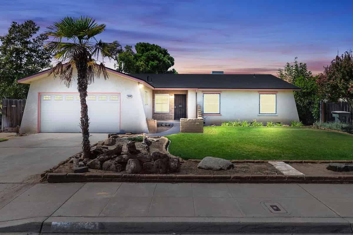 a home with a palm tree in the front yard