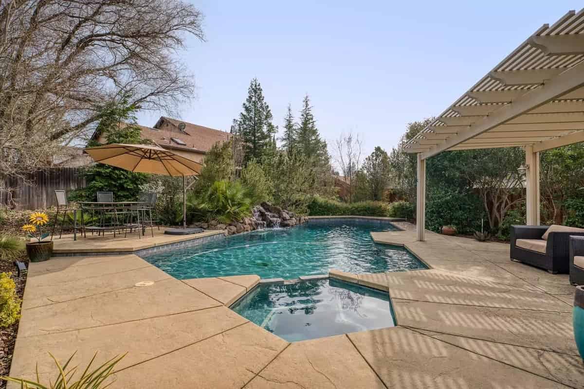 a pool with a patio and a patio area