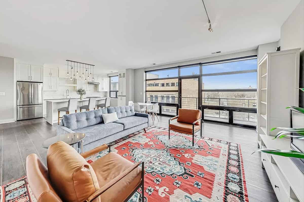 a living room with a couch, a couch, and a television