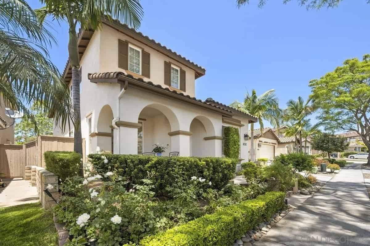 a house with a driveway and palm trees