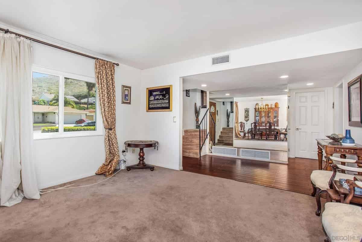 a living room with a large window and a couch