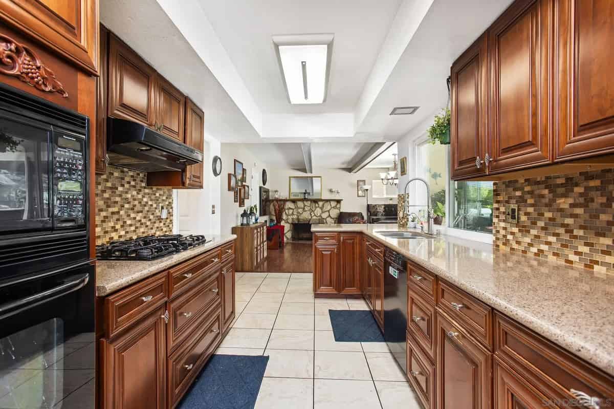 a kitchen with wooden cabinets and granite counter tops