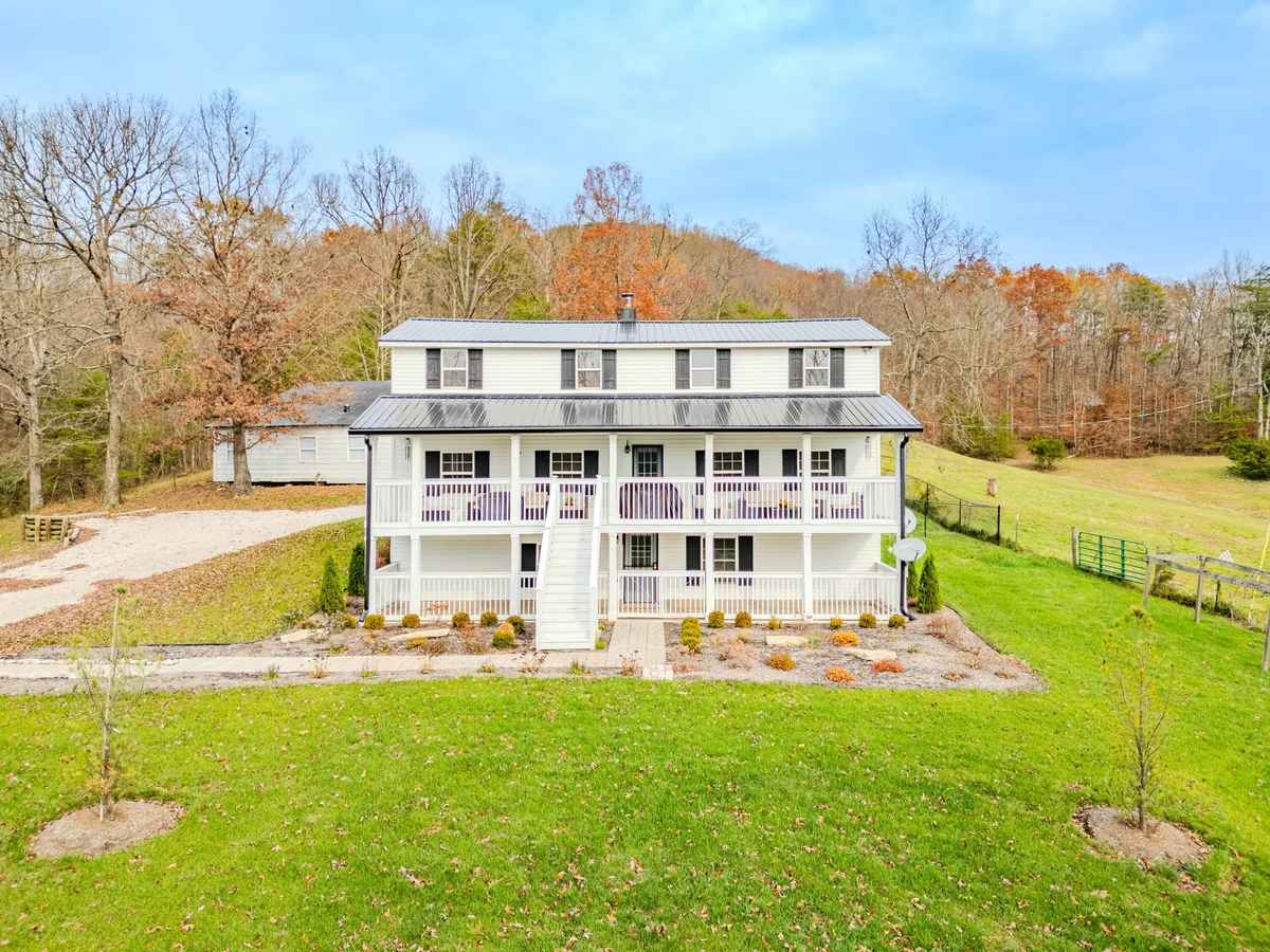 a white house with a large yard and a large yard