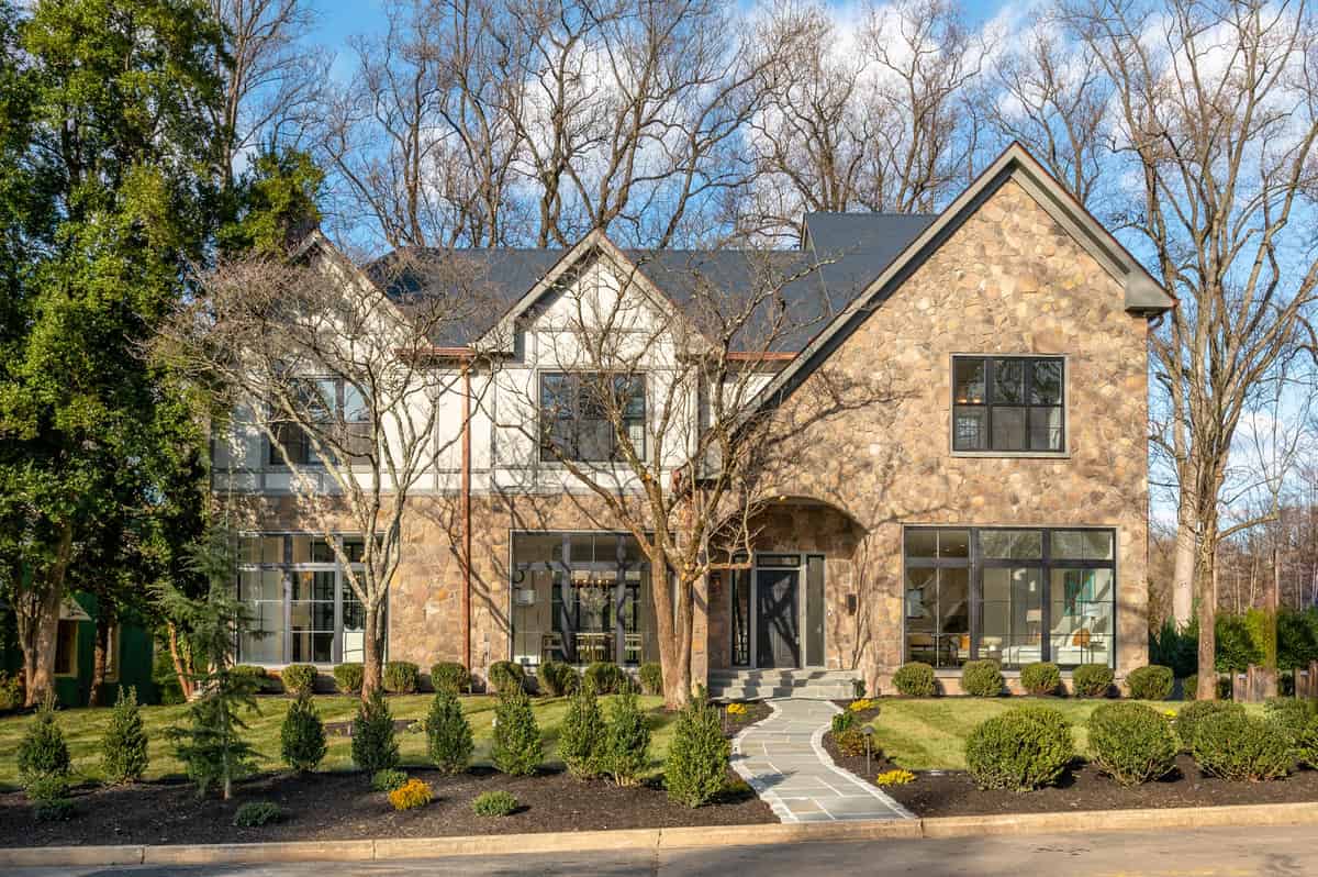 a house with a lot of windows and a lot of trees